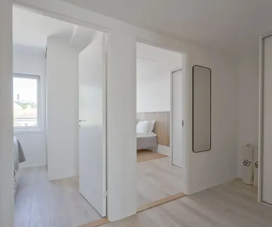 a room with white walls and doors
