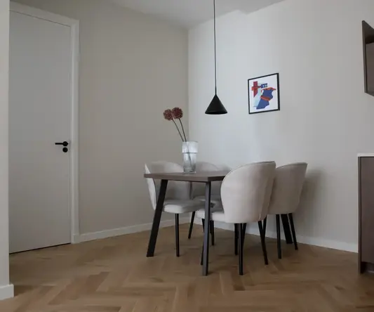 a dining table with chairs in a room