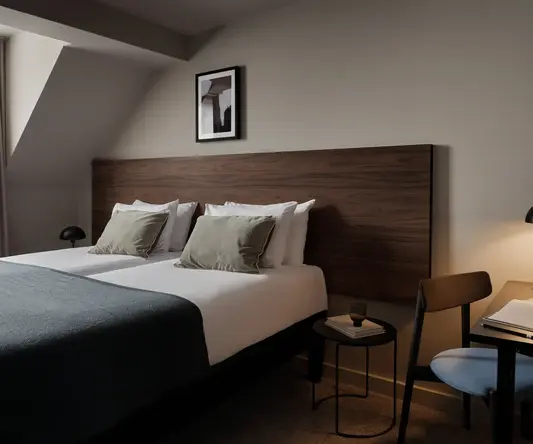 a bed with a wood headboard and a lamp