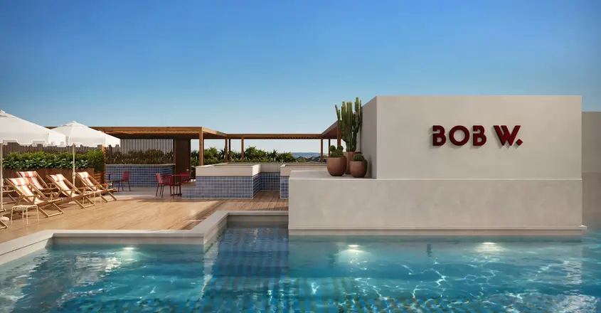 a pool with a building and a roof