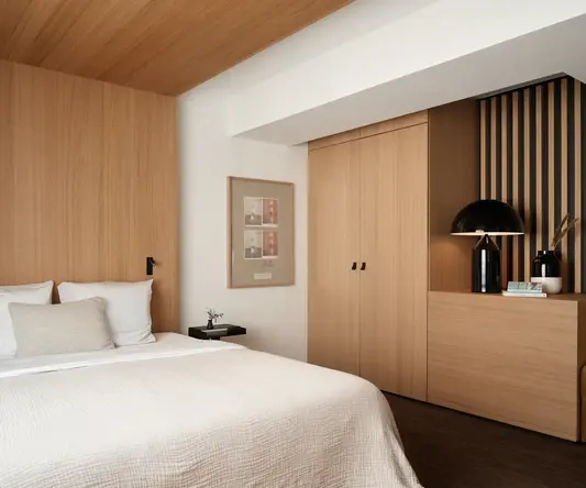 a bedroom with a bed and a lamp