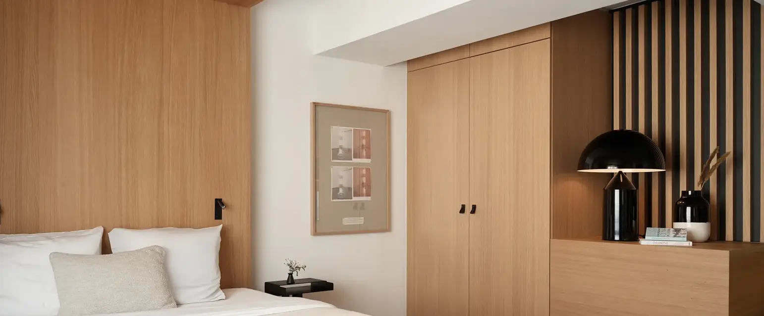 a bedroom with a bed and a lamp