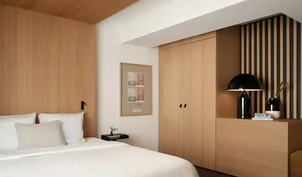 a bedroom with a bed and a lamp