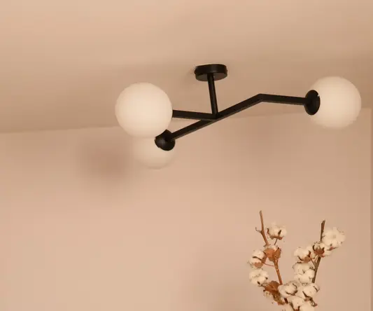 a table with chess board and a vase of cotton