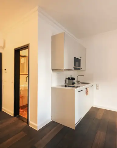 a kitchen with a wood floor and a door