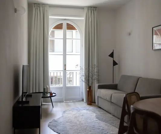 a living room with a couch and a rug