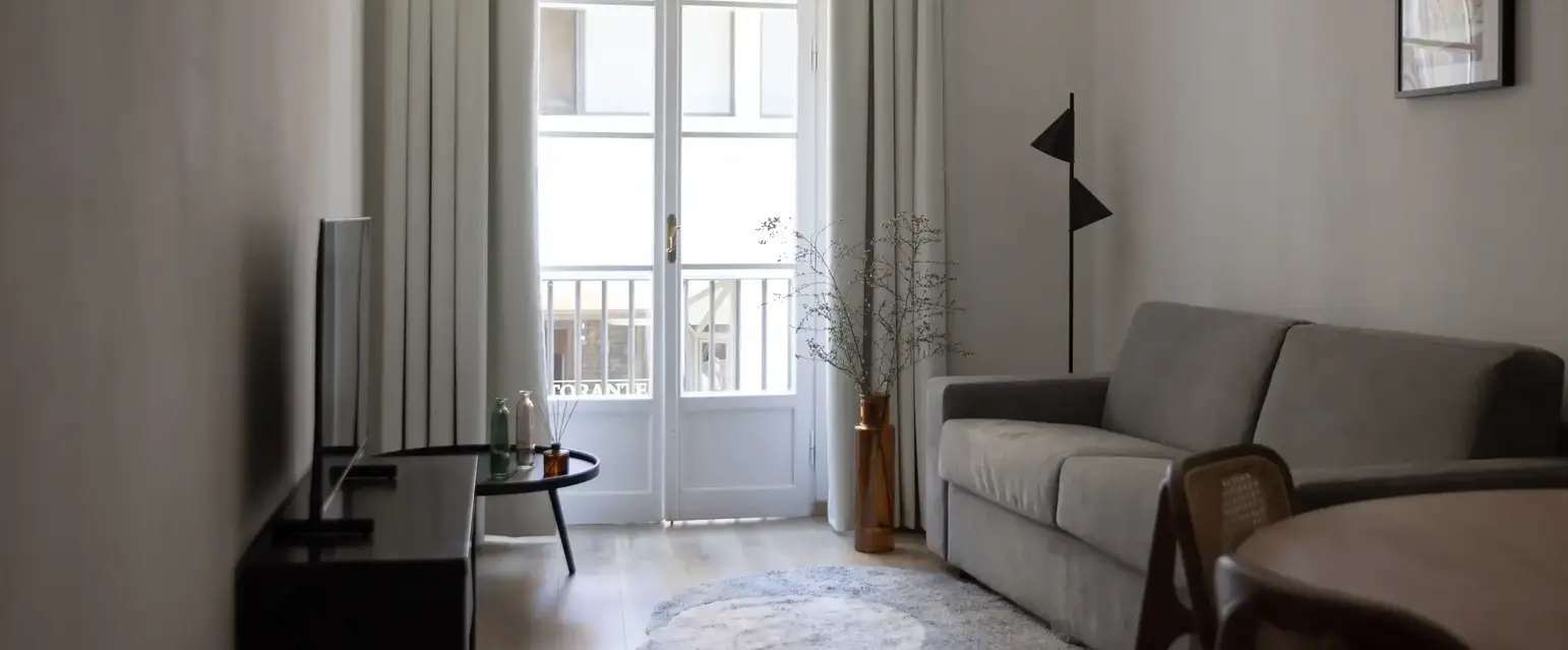 a living room with a couch and a rug