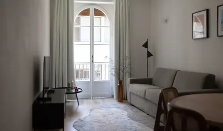 a living room with a couch and a rug