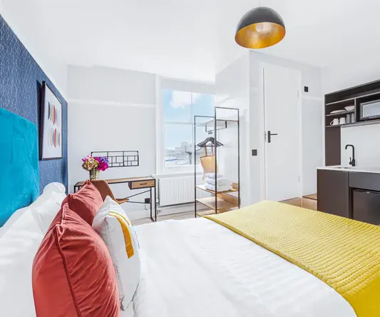 a bedroom with a bed and a sink