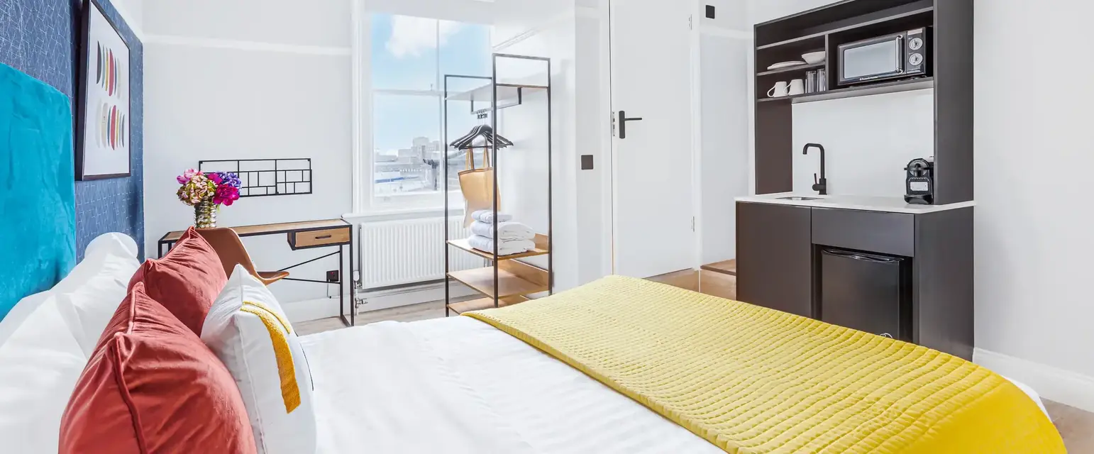 a bedroom with a bed and a sink