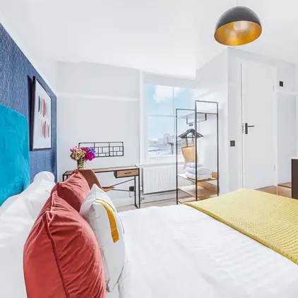 a bedroom with a bed and a sink