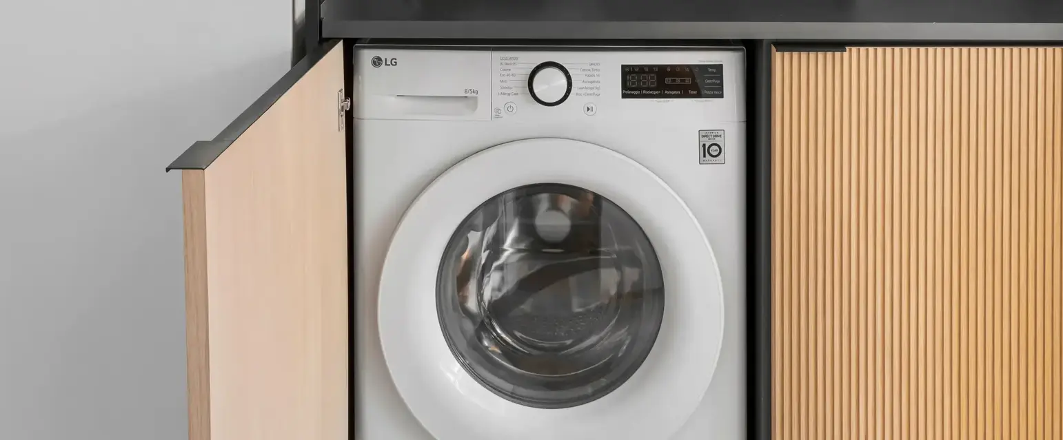 a laundry room with a washing machine and a black box
