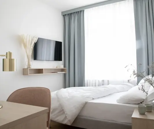 a bedroom with a tv and a bed