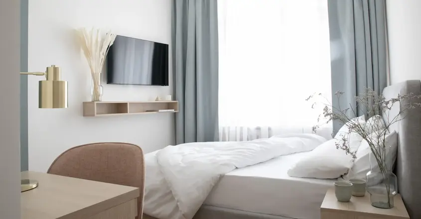 a bedroom with a tv and a bed