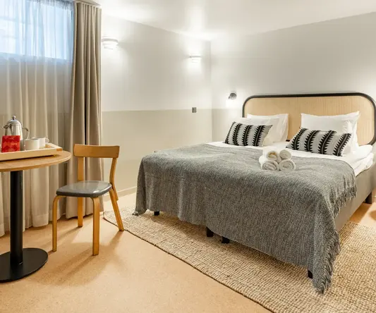 a bed with a table and chairs