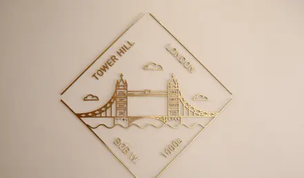 a gold logo on a white surface