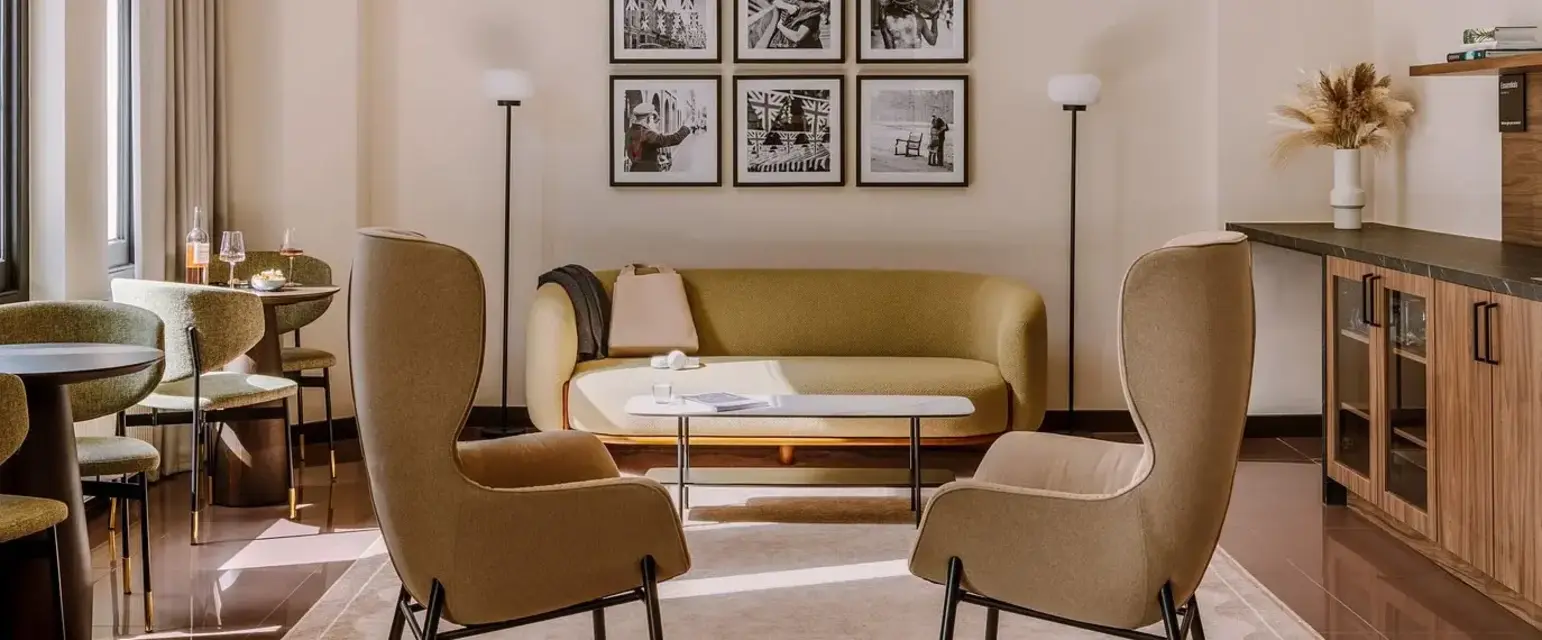 a room with a couch and chairs