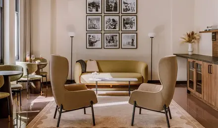 a room with a couch and chairs