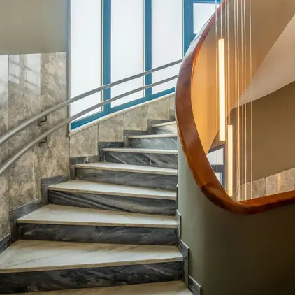 a staircase with a curved railing