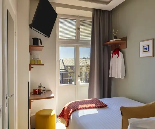 a room with a bed and a television