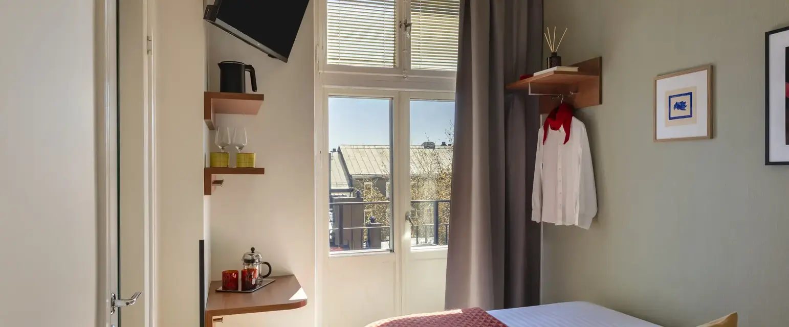 a room with a bed and a television