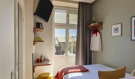 a room with a bed and a television