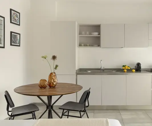 a kitchen with a table and chairs