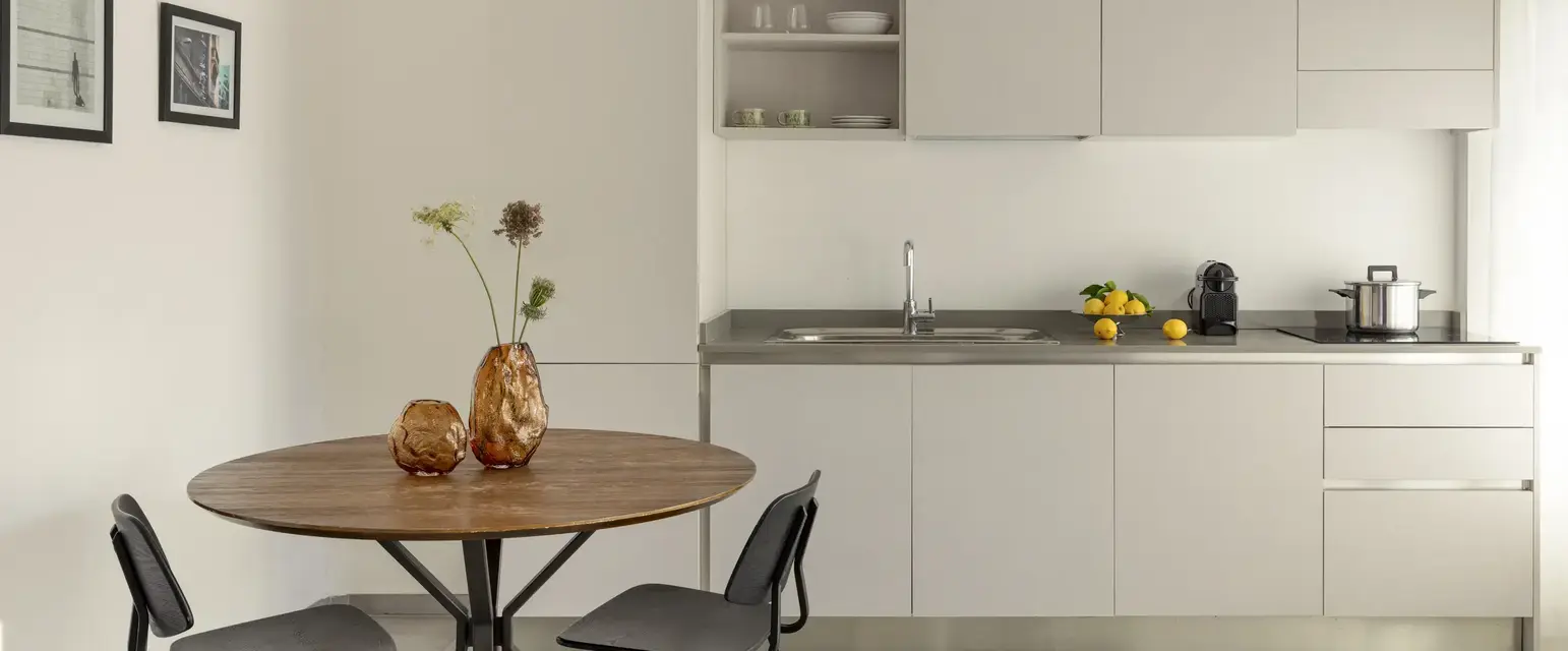 a kitchen with a table and chairs
