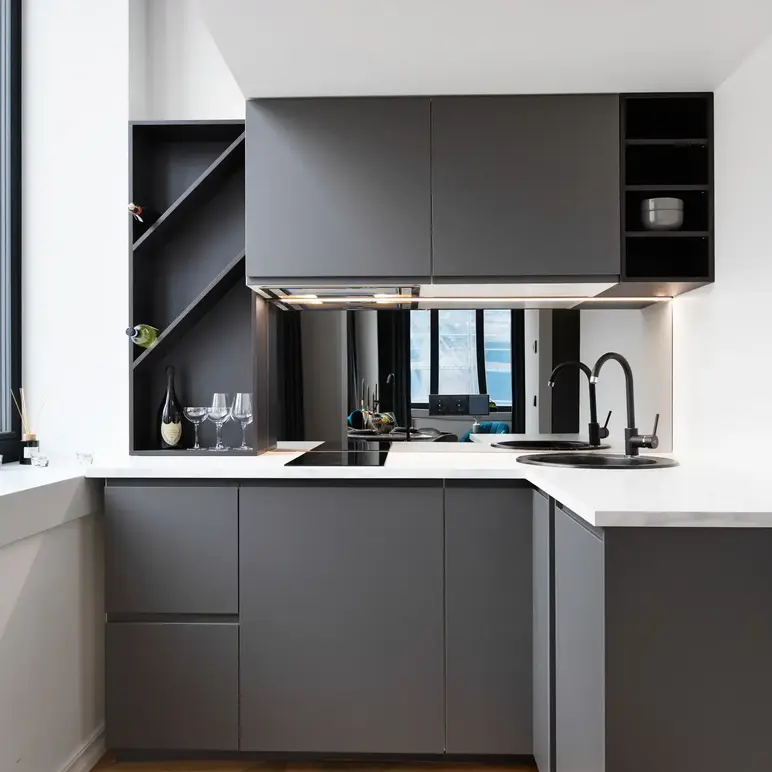 a kitchen with grey cabinets and a black sink