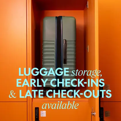a green suitcase in an orange locker