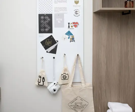 a white board with black and white designs on it and a shelf with sticks