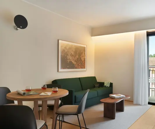 a living room with a green couch and table