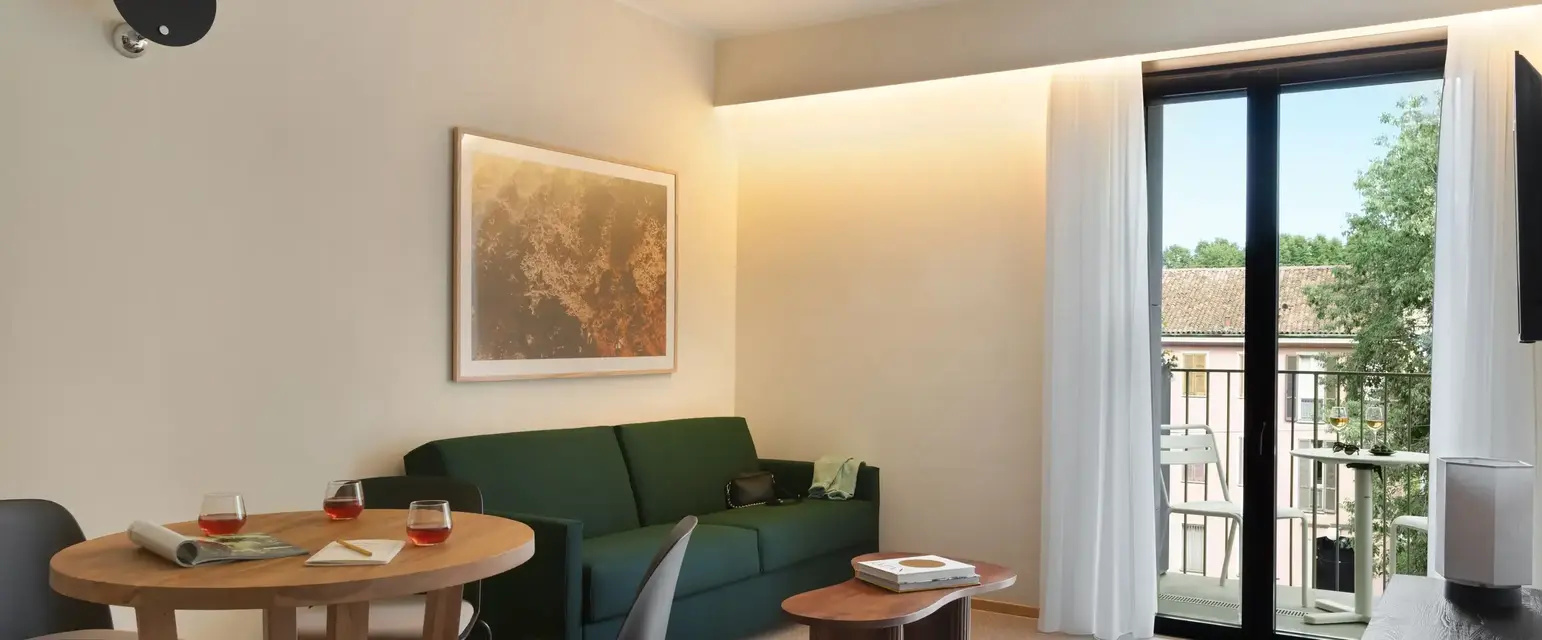 a living room with a green couch and table