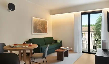 a living room with a green couch and table