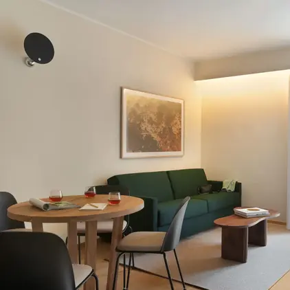 a living room with a green couch and table
