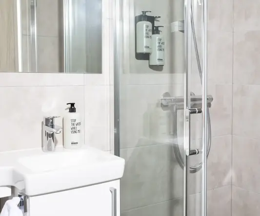 a bathroom with a glass shower door