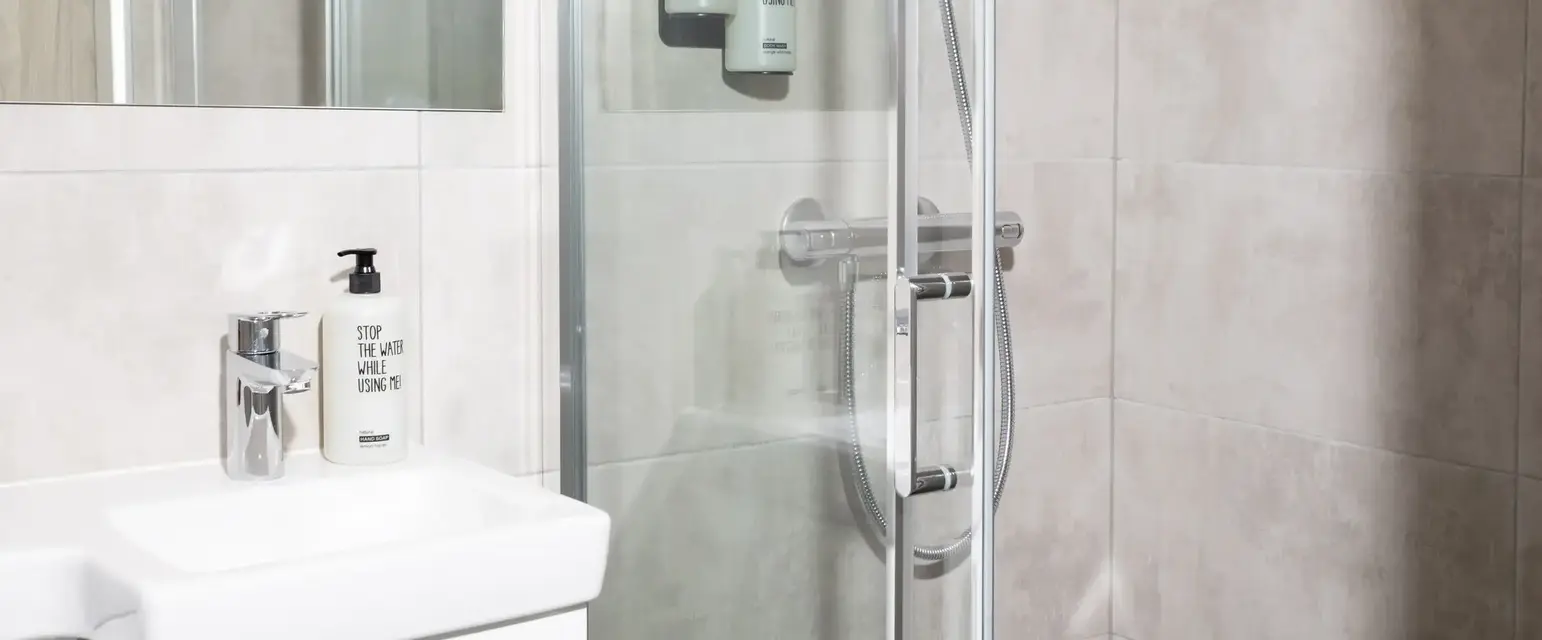 a bathroom with a glass shower door