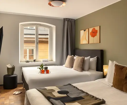 a room with two beds and a window
