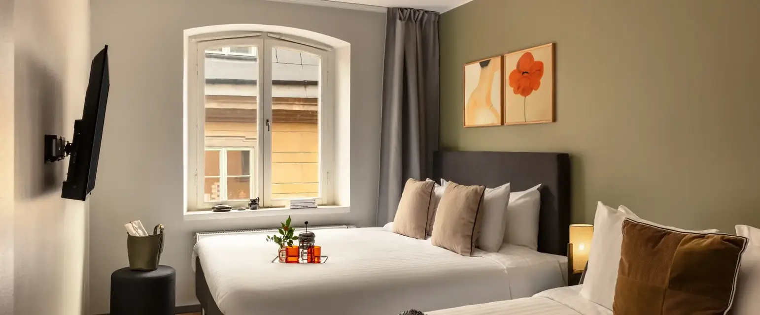 a room with two beds and a window