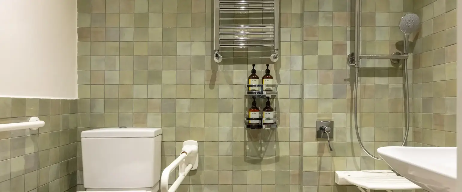 a bathroom with a toilet and a shower