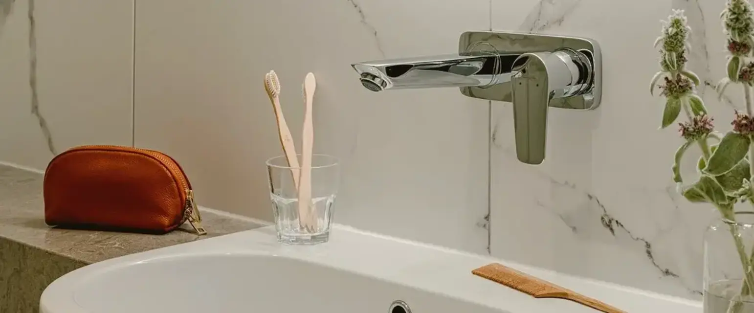 a bathroom with a round mirror