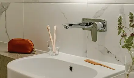 a bathroom with a round mirror