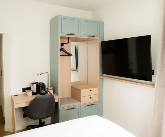 a room with a tv and a mirror