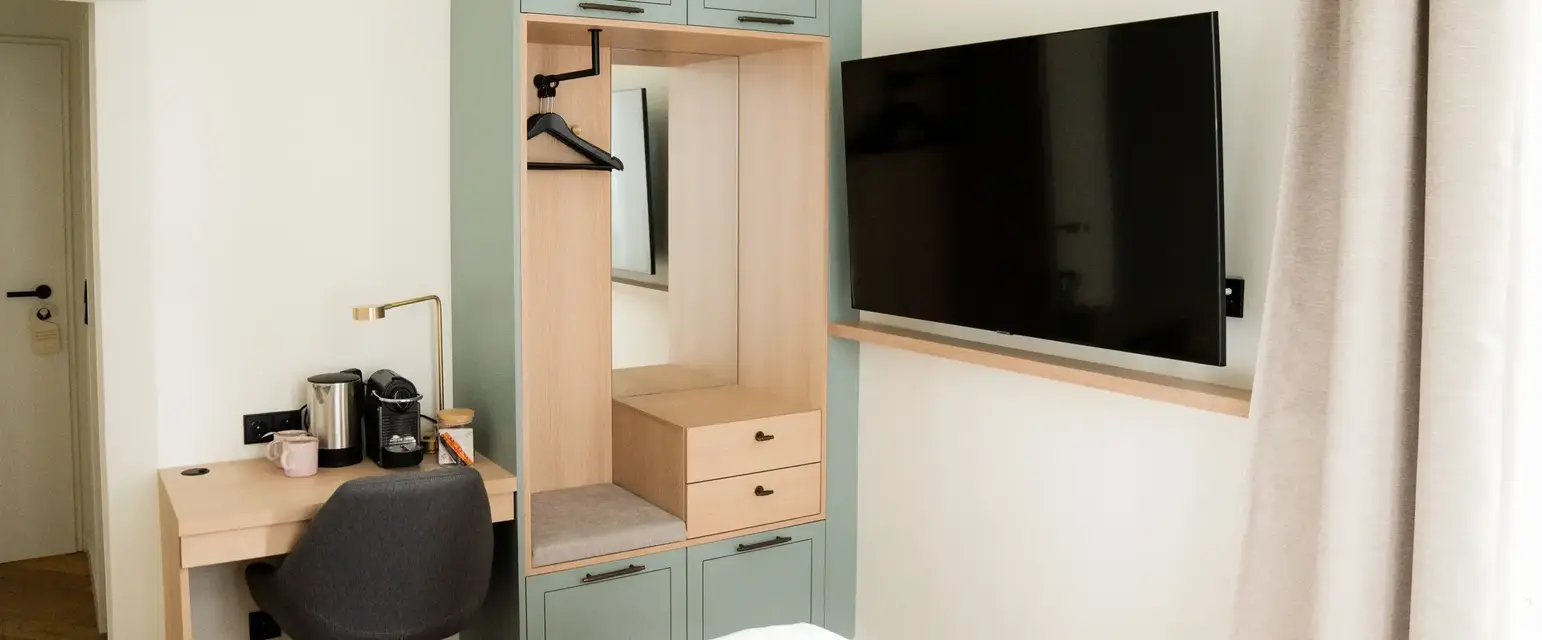 a room with a tv and a mirror