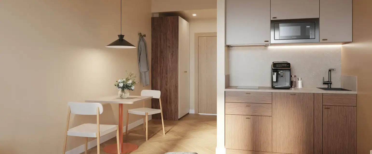 a room with a bed and a table and chairs