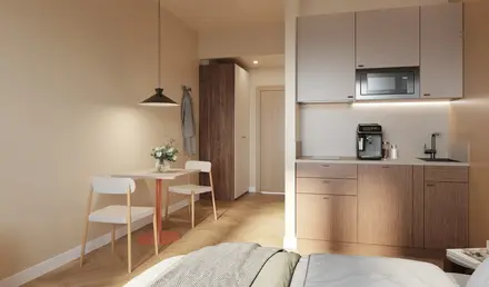 a room with a bed and a table and chairs