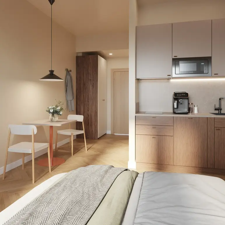 a room with a bed and a table and chairs