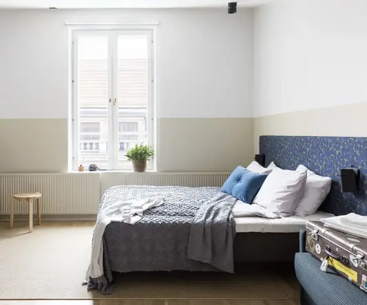 a bedroom with a bed and a tv