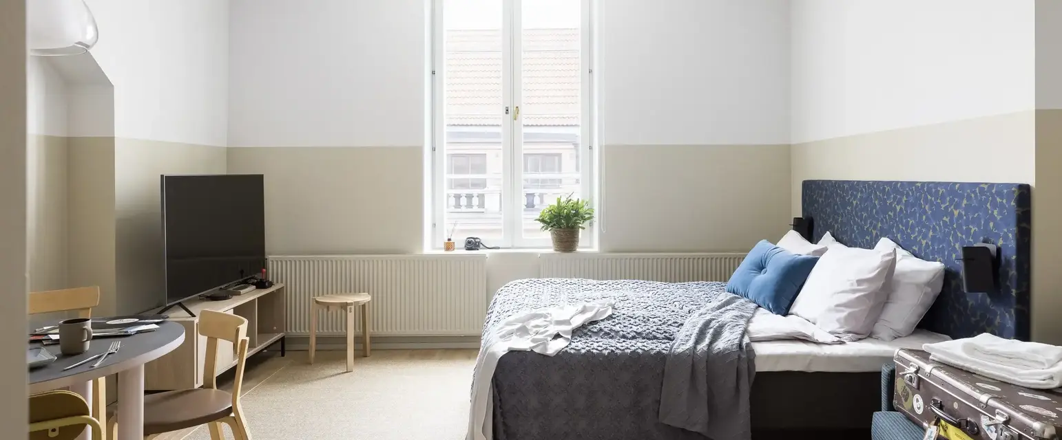 a bedroom with a bed and a tv