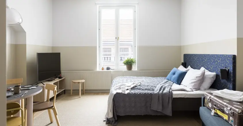 a bedroom with a bed and a tv